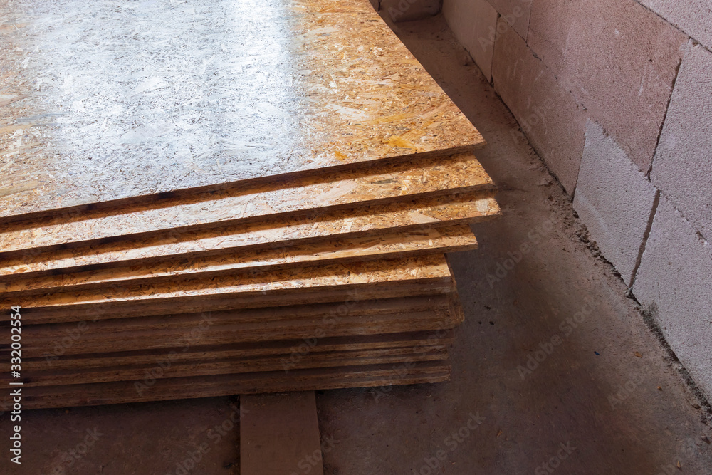 OSB slab building material made from reborn sawdust. They are stacked. Close-up