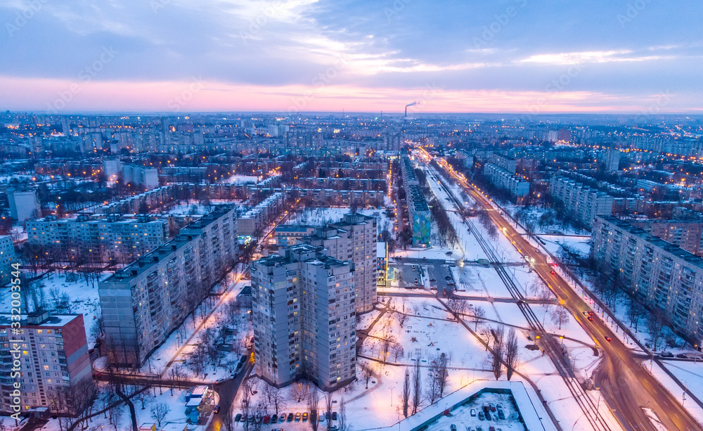 Obraz premium Aerial city winter view with crossroads and roads, houses, buildings, parks. Helicopter drone shot. Wide Panoramic image. Kharkiv, Ukraine