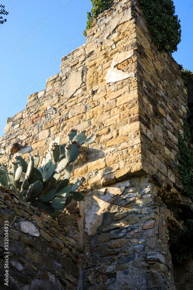 Bussana Vecchia (IM), Italy - December 12, 2017: An old wall with stones in Bussana Vecchia, Imperia, Liguria, Italy Bussana Vecchia (IM), Italy - December 12, 2017: An old wall with stones in Bussana Vecchia, Imperia, Liguria, Italy