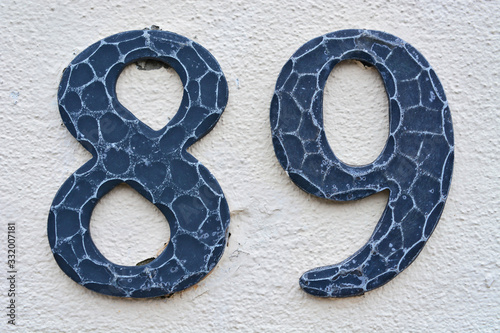A house number plaque, showing the number eighty nine (89) photo