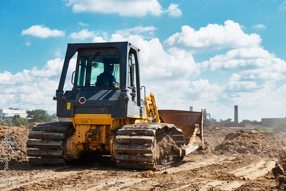 Buldozer moving earth. Road construction building work Buldozer moving earth. Road construction building work