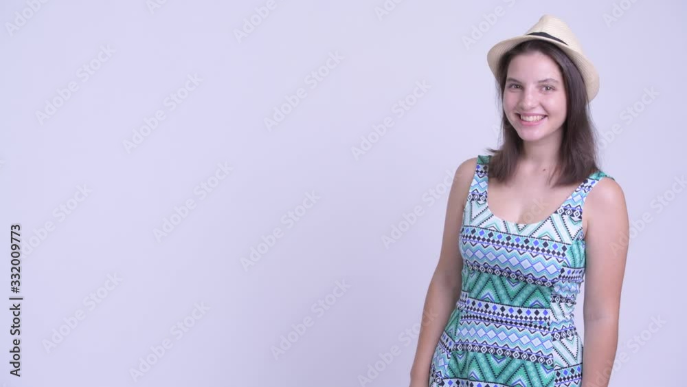 Happy young beautiful tourist woman touching something and looking surprised Happy young beautiful tourist woman touching something and looking surprised