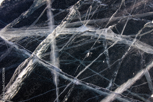 Ice pattern view with breaks and bubbles, frozen Baikal Lake, Russia