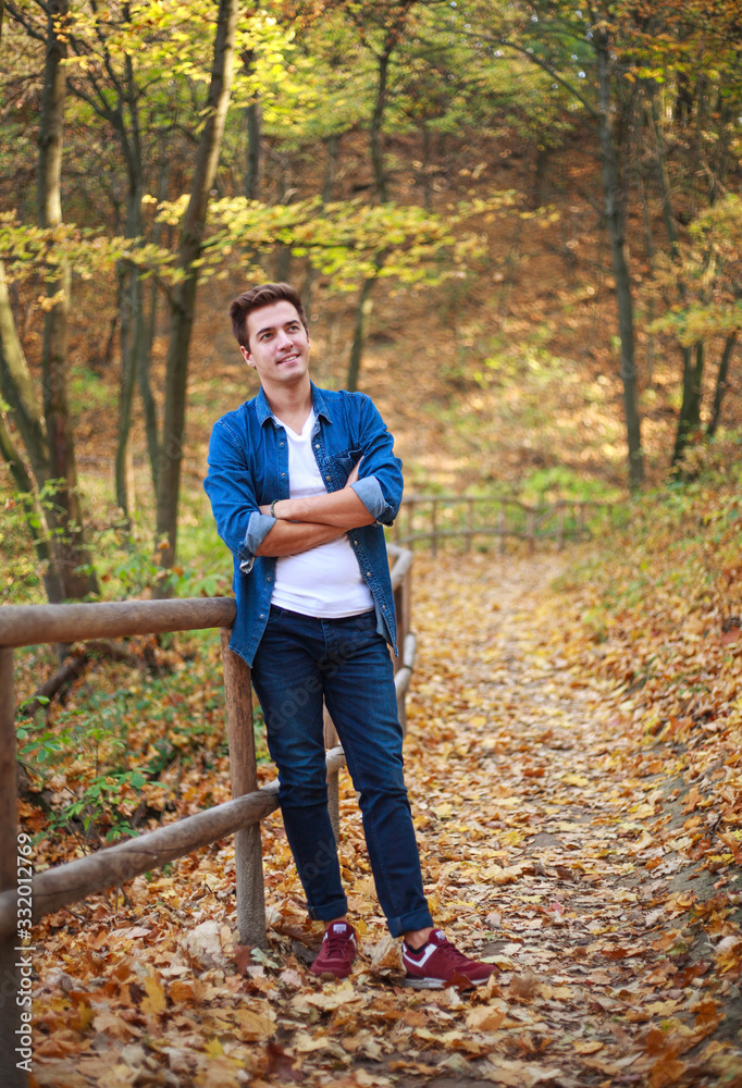 Young pensive and dreamy guy man in forest park enjoy relaxation and freshness of nature Young pensive and dreamy guy man in forest park enjoy relaxation and freshness of nature
