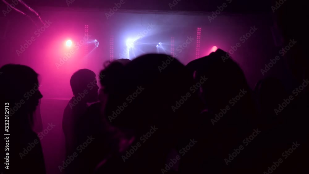 A crowd of people dancing at a music festival. A party in the big hall A crowd of people dancing at a music festival. A party in the big hall