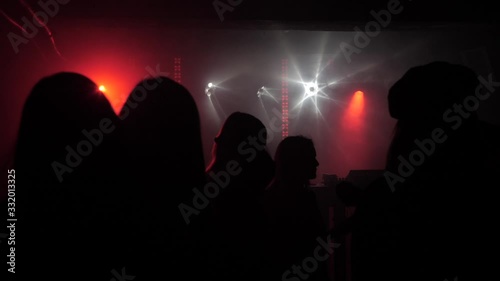 A crowd of people dancing at a music festival. A party in the big hall
