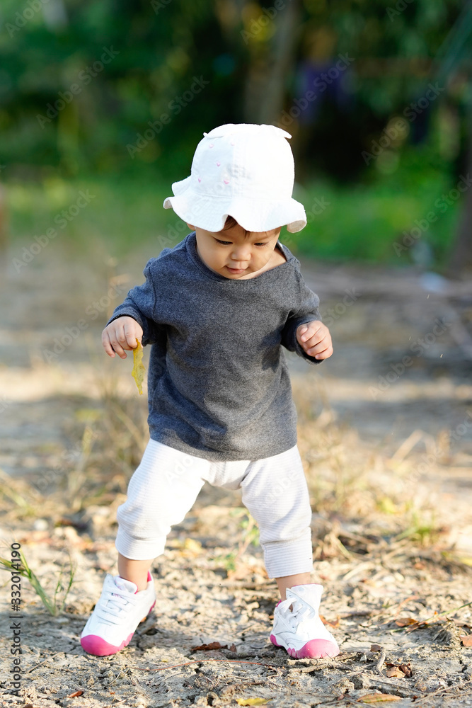 Cute and adorable child playing in garden with joyful Cute and adorable child playing in garden with joyful