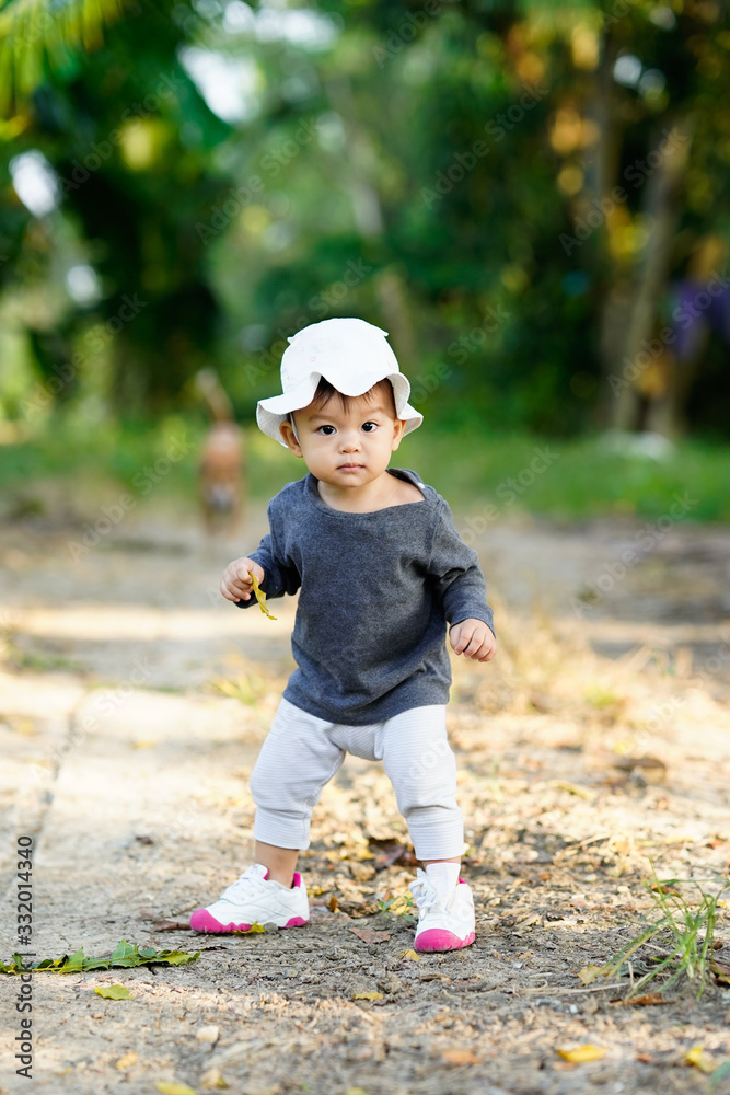 Cute and happy asian baby girl playing with joyful in garden Cute and happy asian baby girl playing with joyful in garden