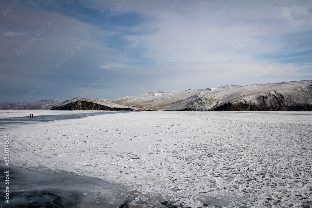 Frozen winter landscape view of Olkhon Island and Baikal Lake covered by snow, Russia
