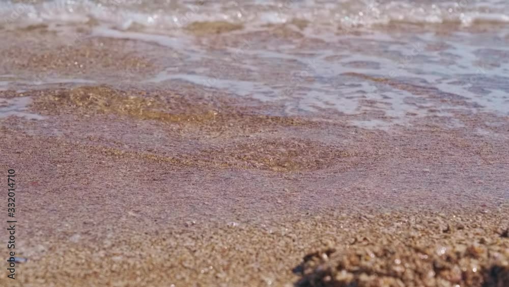 Waves wash footprints in the sand Waves wash footprints in the sand