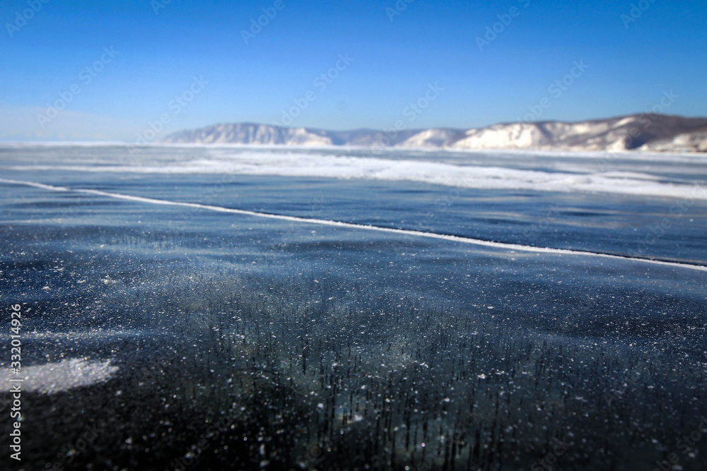 Pure ice of frozen Baikal Lake view near Olkhon Island, Russia Pure ice of frozen Baikal Lake view near Olkhon Island, Russia