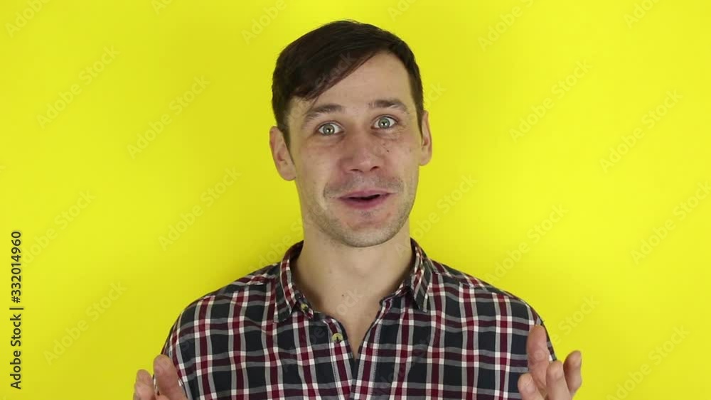A funny, cute guy is having a video chat conversation. A portrait of a young guy, he communicates with friends via video chat. Portrait on a yellow background. A funny, cute guy is having a video chat conversation. A portrait of a young guy, he communicates with friends via video chat. Portrait on a yellow background.