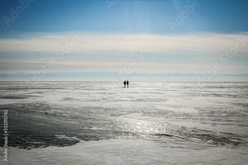 Two strangers and endless frozen Baikal Lake, Russia