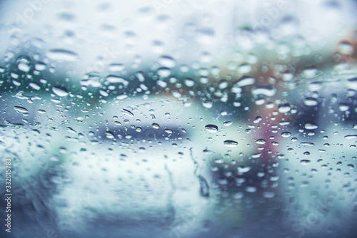 Abstract background of rain water drop on front car window.