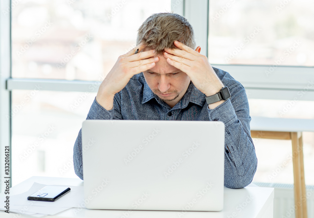 Puzzled businessman looking in laptop Puzzled businessman looking in laptop