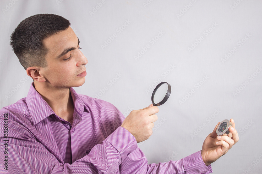 looking through a magnifying glass at a compass looking through a magnifying glass at a compass