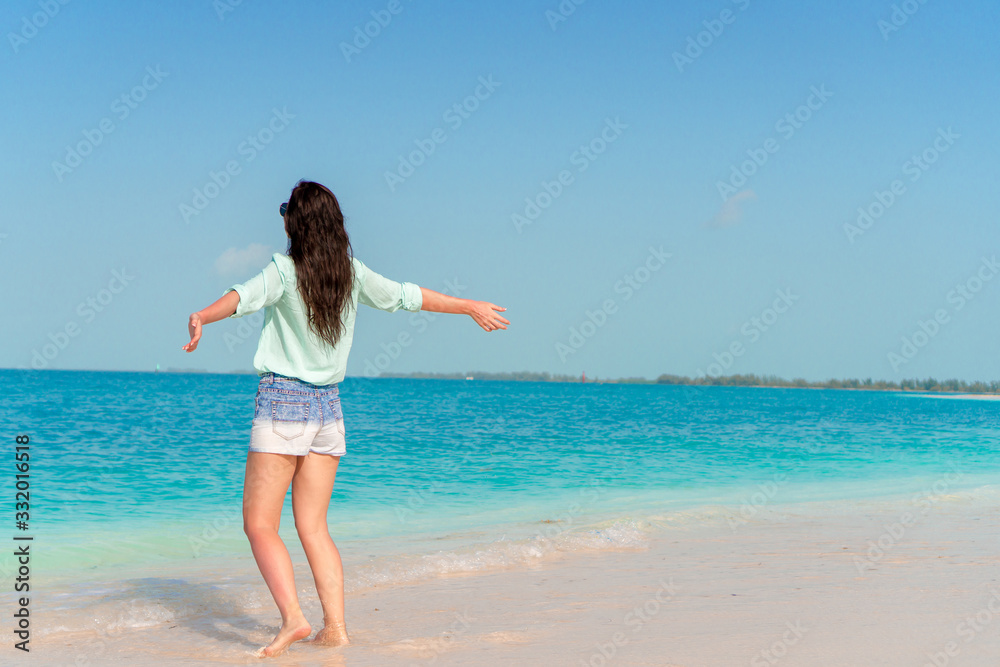 Woman laying on the beach enjoying summer holidays looking at the sea Woman laying on the beach enjoying summer holidays looking at the sea