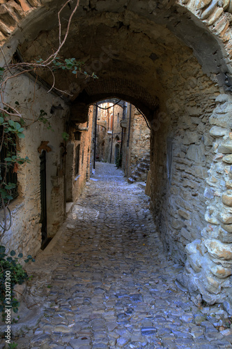 Fototapeta Naklejka Na Ścianę i Meble -  Bussana Vecchia (IM), Italy - December 12, 2017: A typical house and pathway in Bussana Vecchia, Imperia, Liguria, Italy