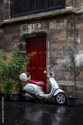 Photography The scooter parked near red door.