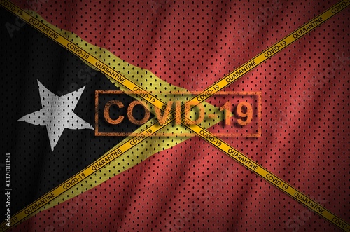 Timor Leste flag and Covid-19 stamp with orange quarantine border tape cross. Coronavirus or 2019-nCov virus concept photo