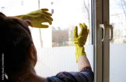 A woman at the window of her home