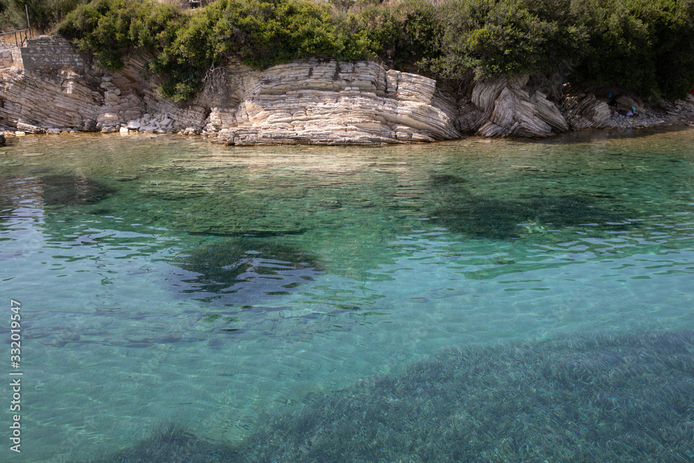 Kastos island summer picturesque nature with turquoise crystal clear water, rocks, green trees - Ionian sea, Greece. Kastos island summer picturesque nature with turquoise crystal clear water, rocks, green trees - Ionian sea, Greece.