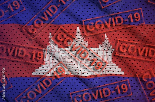 Cambodia flag and many red Covid-19 stamps. Coronavirus or 2019-nCov virus concept photo