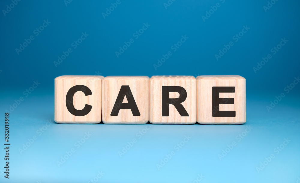 CARE - text on wooden blocks, personal opinions prejudice, blue background CARE - text on wooden blocks, personal opinions prejudice, blue background
