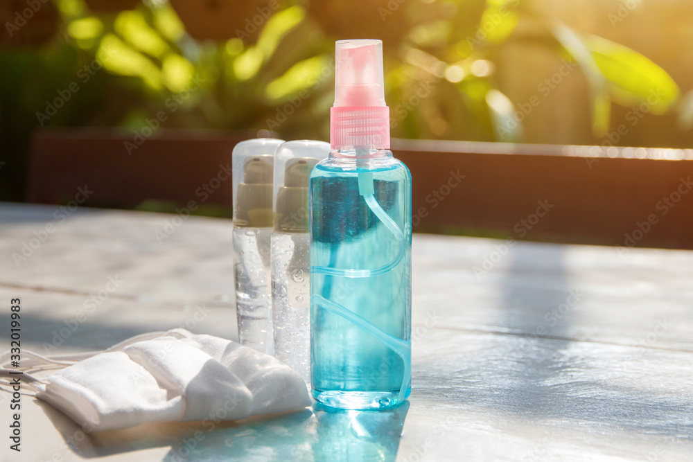 Alcohol ge and alcohol and surgical mask on the table for anti bacteria soap to make hands cleaning and clear germ, bacteria,corona virus Alcohol ge and alcohol and surgical mask on the table for anti bacteria soap to make hands cleaning and clear germ, bacteria,corona virus