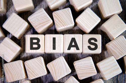Bias - text on wooden blocks, personal opinions prejudice, cubes around background photo