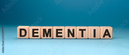 Dementia word cube on a blue background. Medical concept.
