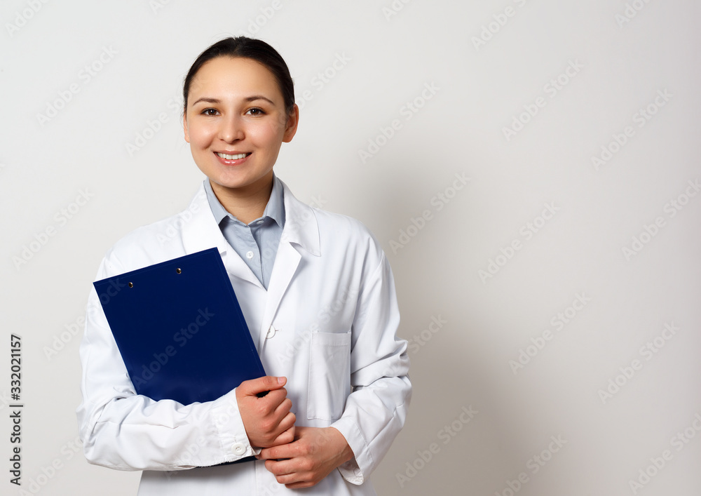 portrait of a female medical worker. Young doctor with clipboard on white portrait of a female medical worker. Young doctor with clipboard on white