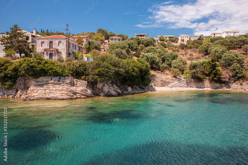 Kastos island summer picturesque nature with turquoise crystal clear water, rocks, green trees, houses - Ionian sea, Greece.