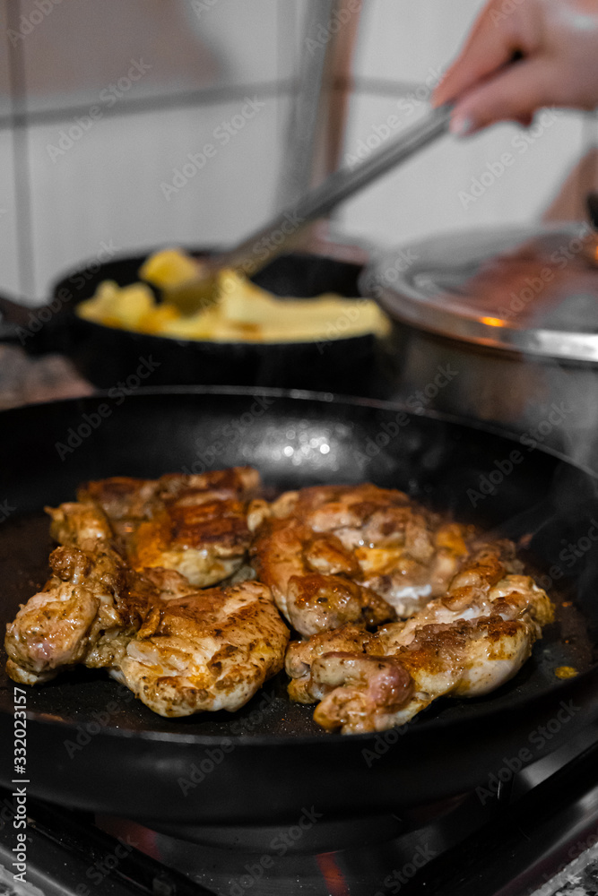 Chicken meat cooked in the pan in the home kitchen