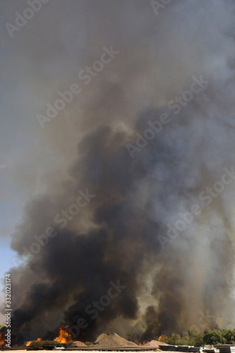 Brush fire in desert emitting large black plumes of smoke, east of Needles in Arizona