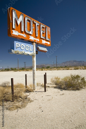 Old 1950's neon sign reading Motel Pool in remote part of desert of Arizona