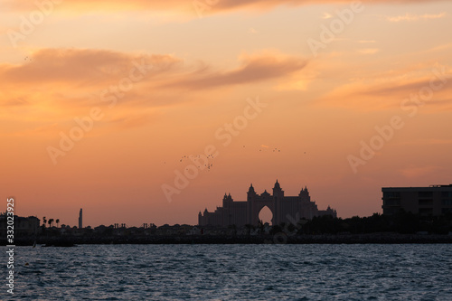 silhouette of the building on the sea shore sunset