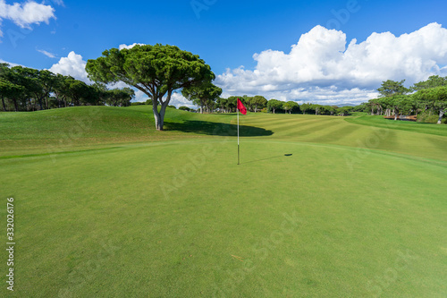 Beautiful, empty golf course with blue sky and green grass