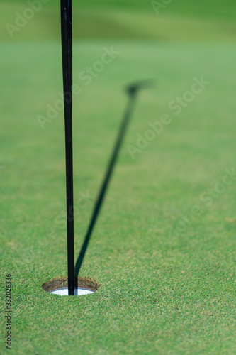 Golf hole, golf flag and green grass