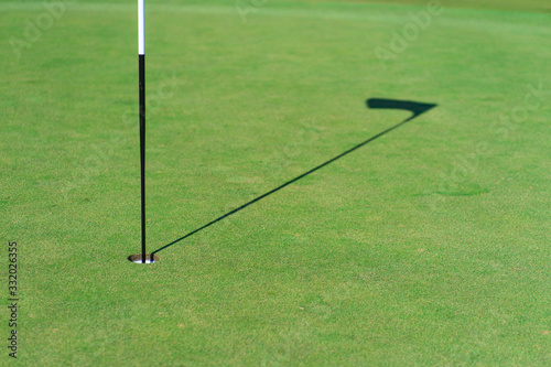 Golf hole, golf flag and green grass