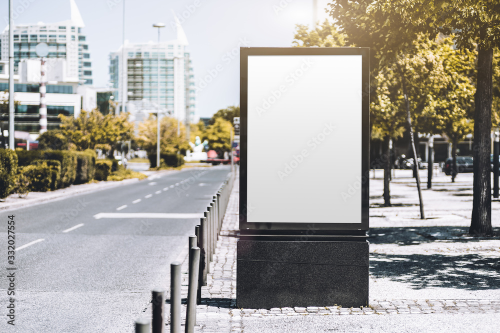 Mockup of an empty information poster in urban settings near a city road; a blank vertical street banner template on the sidewalk in alleyway; an outdoor billboard placeholder mock-up near the highway