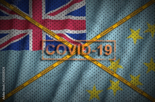 Tuvalu flag and Covid-19 stamp with orange quarantine border tape cross. Coronavirus or 2019-nCov virus concept photo