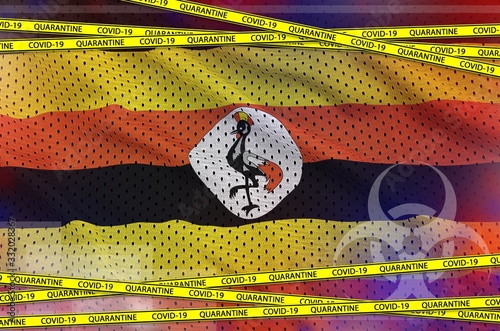 Uganda flag and Covid-19 quarantine yellow tape. Coronavirus or 2019-nCov virus concept photo