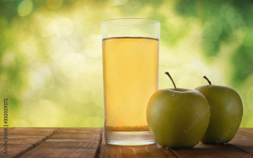 Apple juice on a table in the garden Apple juice on a table in the garden