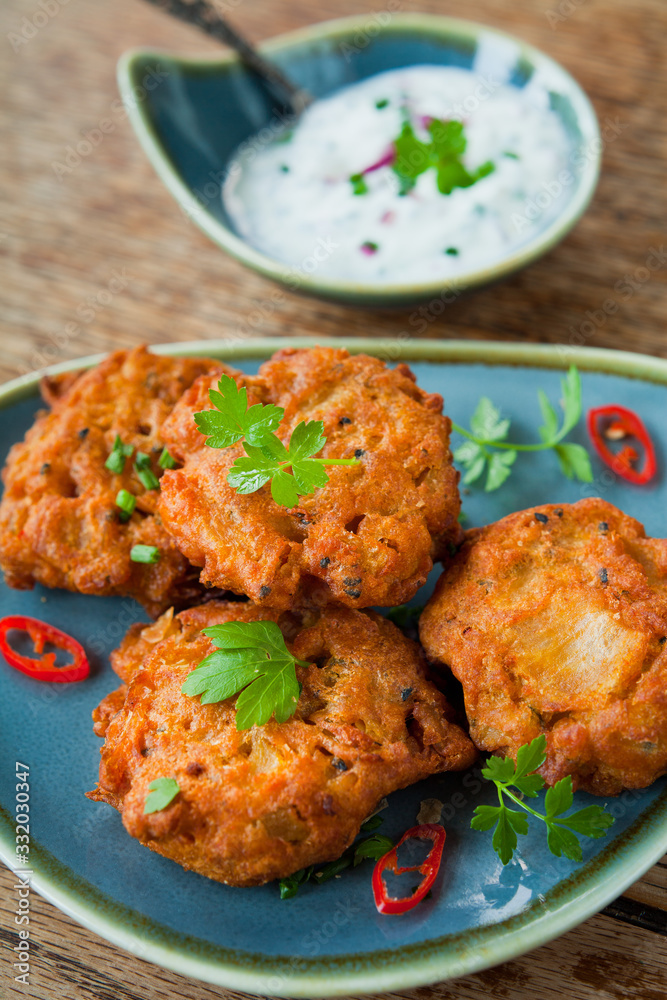 Indian vegetable pakora with fresh raita, chili and coriander leaves. Indian vegetable pakora with fresh raita, chili and coriander leaves.