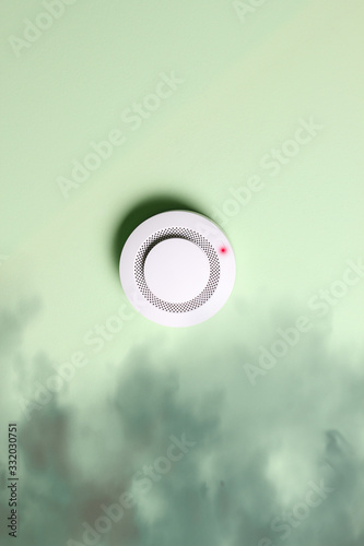 fire alarm sensor on a green light background
