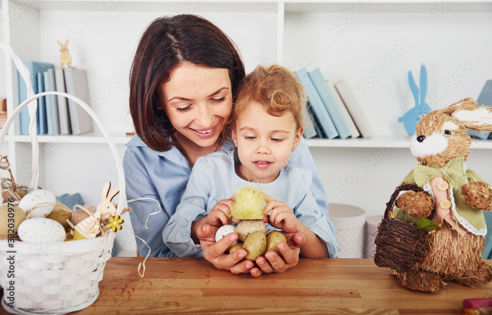 Mother with daughter celebrating Easter holidays together. Holding eggs in hands Mother with daughter celebrating Easter holidays together. Holding eggs in hands