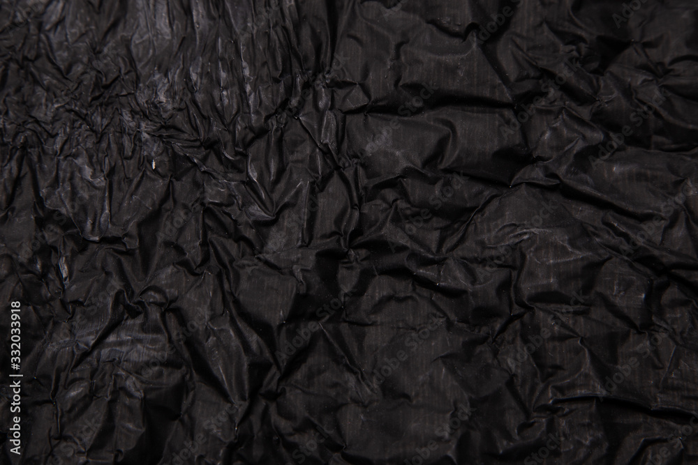 Black background. A crumpled texture. Close-up. Black background. A crumpled texture. Close-up.