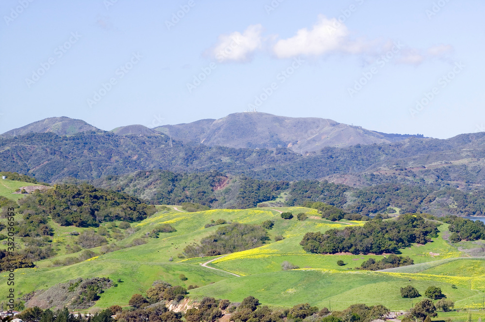 Elevated view of Lake Casitas and green fields in spring, shot from Oak View, near Ojai, California