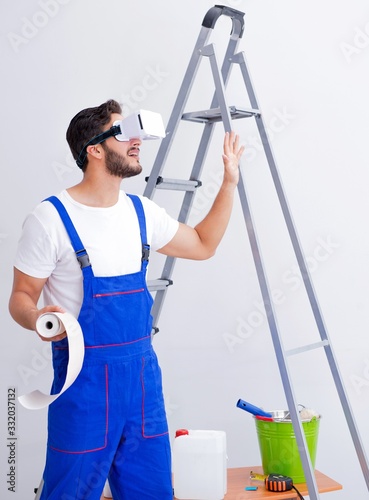 Man with VR glasses gluing wallpaper